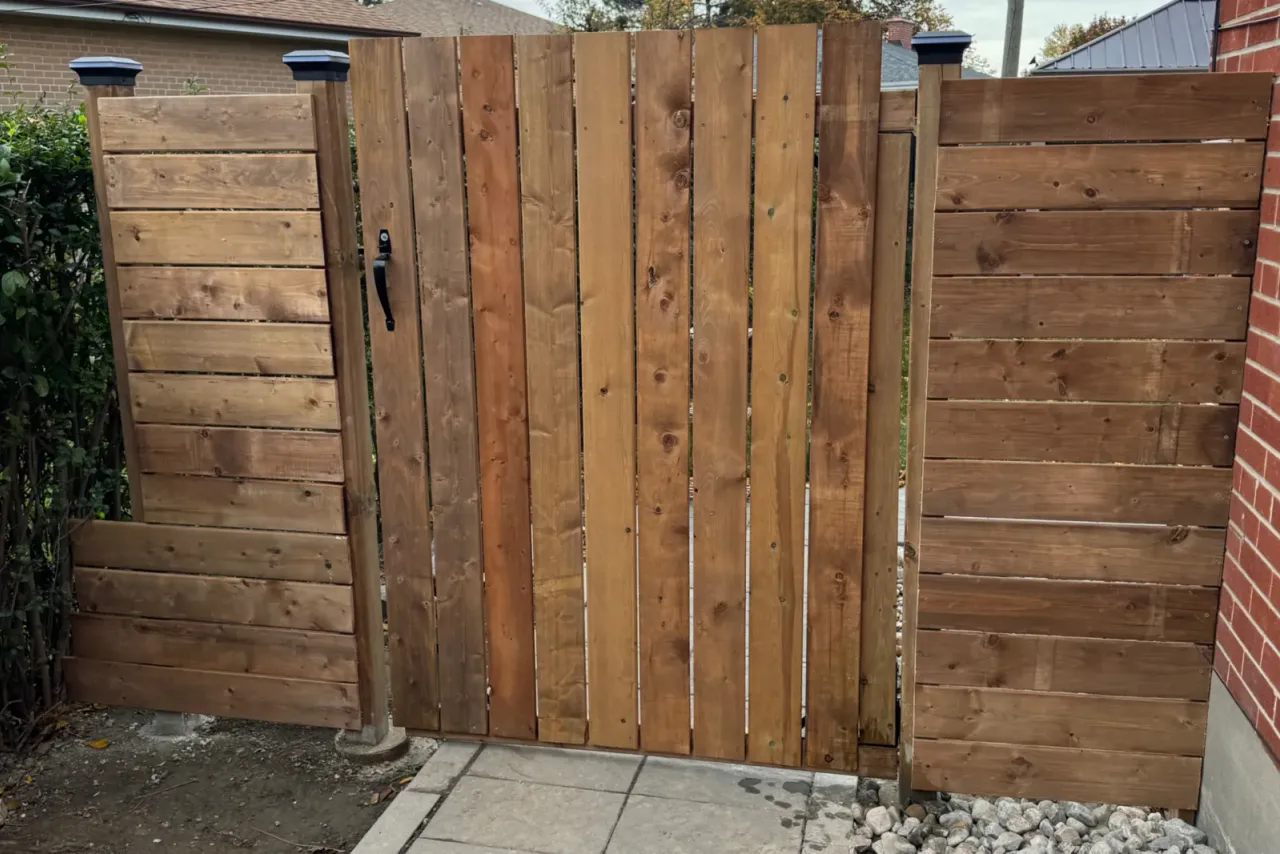 New wooden gate between two horizontal board fence panels