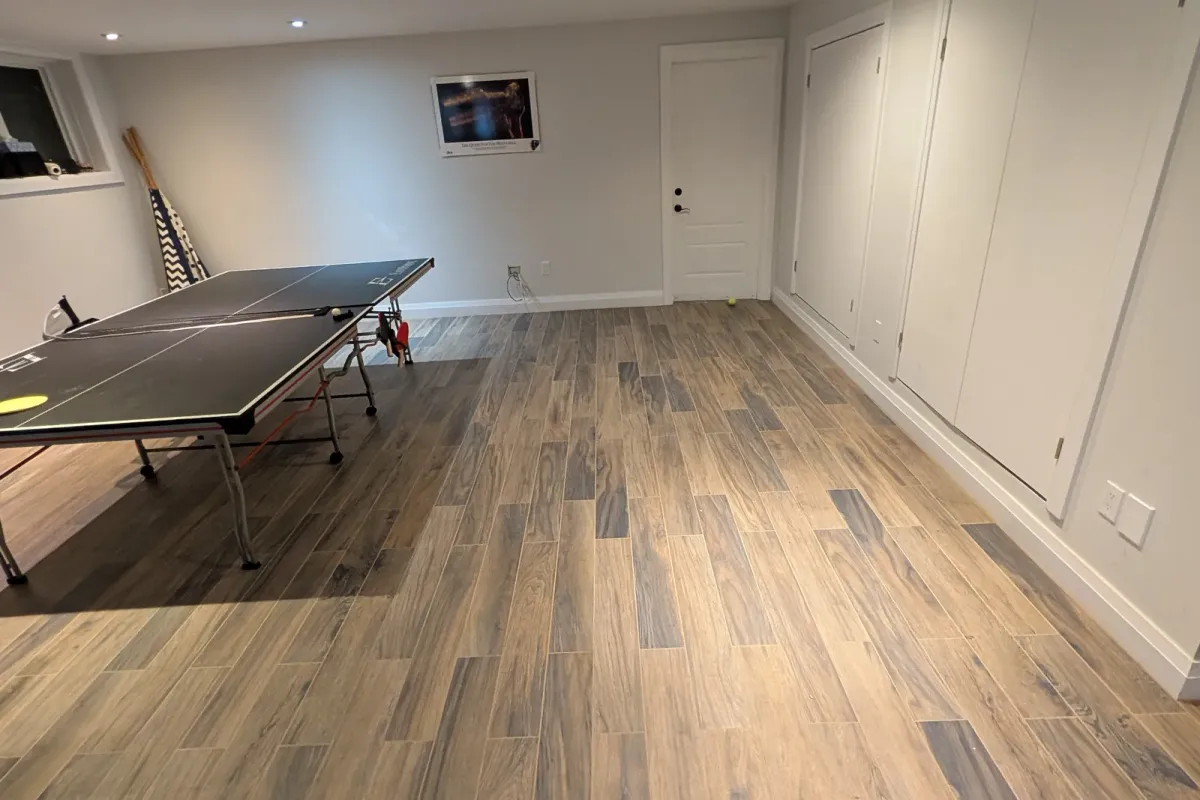 Basement rec room with the floor cleared around a ping-pong table
