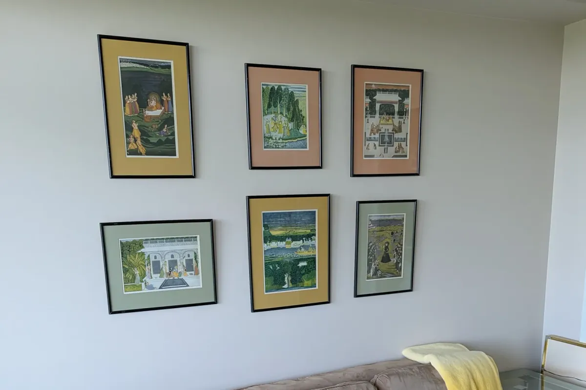 The six framed prints hung in two rows over the sofa
