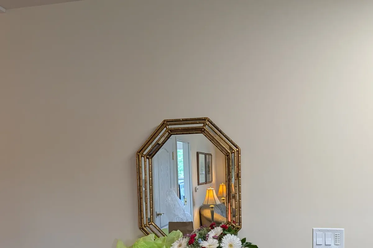 Entry wall with an octagonal gilt mirror and nothing else hung